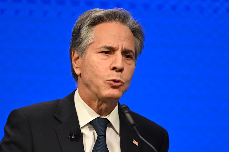 Antony Blinken speaks into a microphone