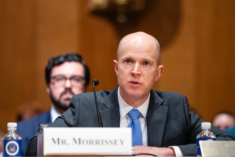 Brian Morrissey testifies in Congress, with a nametag on the table in front of him