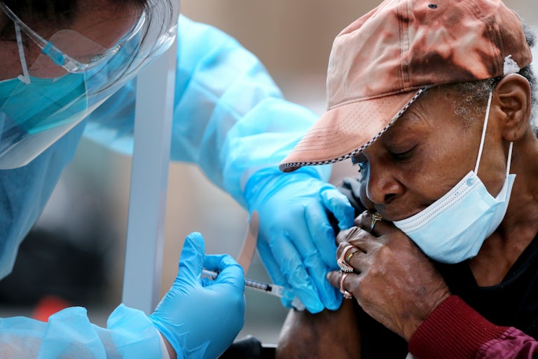 Viola, 75, receives a dose of the Moderna vaccine in Los Angeles