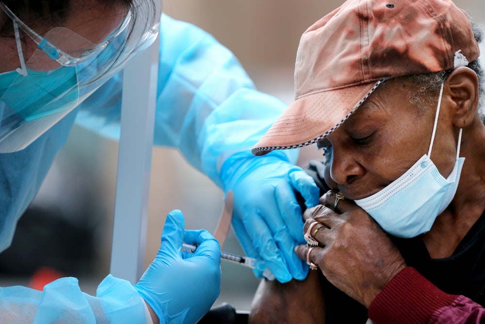 Viola, 75, receives a dose of the Moderna vaccine in Los Angeles