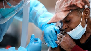 Viola, 75, receives a dose of the Moderna vaccine in Los Angeles