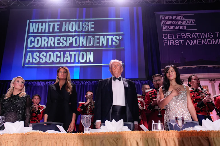 White House press secretary Karoline Leavitt, First Lady Melania Trump, President Donald Trump, and Weijia Jiang, White House Correspondents’ Association president and CBS Senior White House Correspondent, stand in a line at a table during the White House Correspondents’ Association dinner.