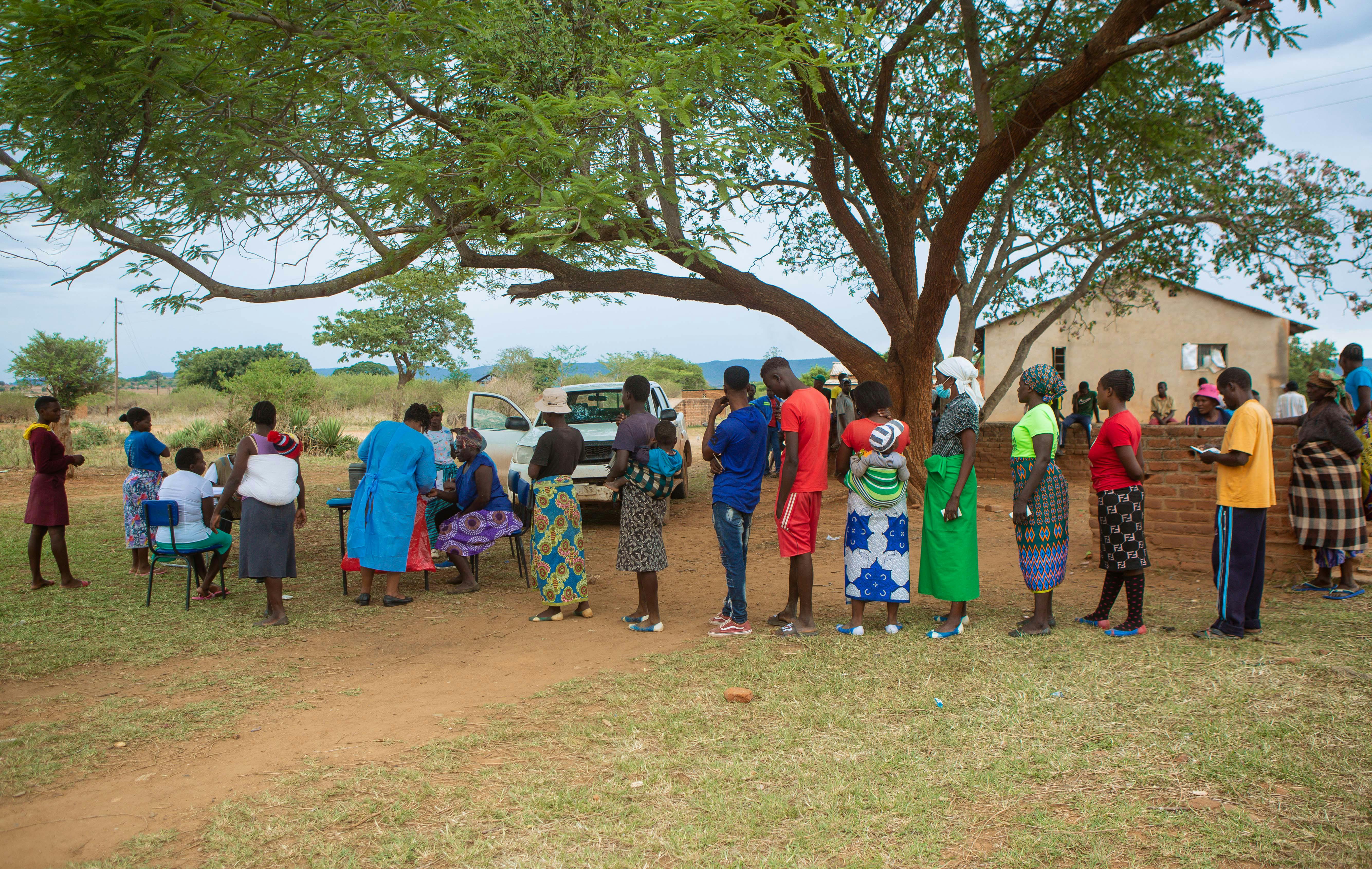People queue for Covid vaccination at Buwi Secondary School in Chinhoyi, Zimbabwe