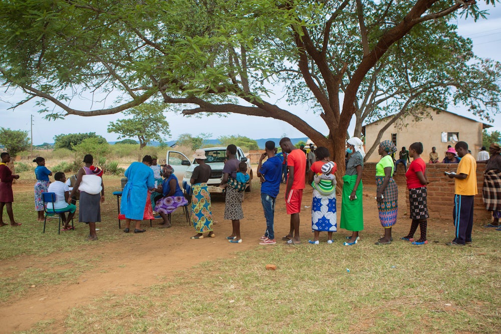 People queue for Covid vaccination at Buwi Secondary School in Chinhoyi, Zimbabwe