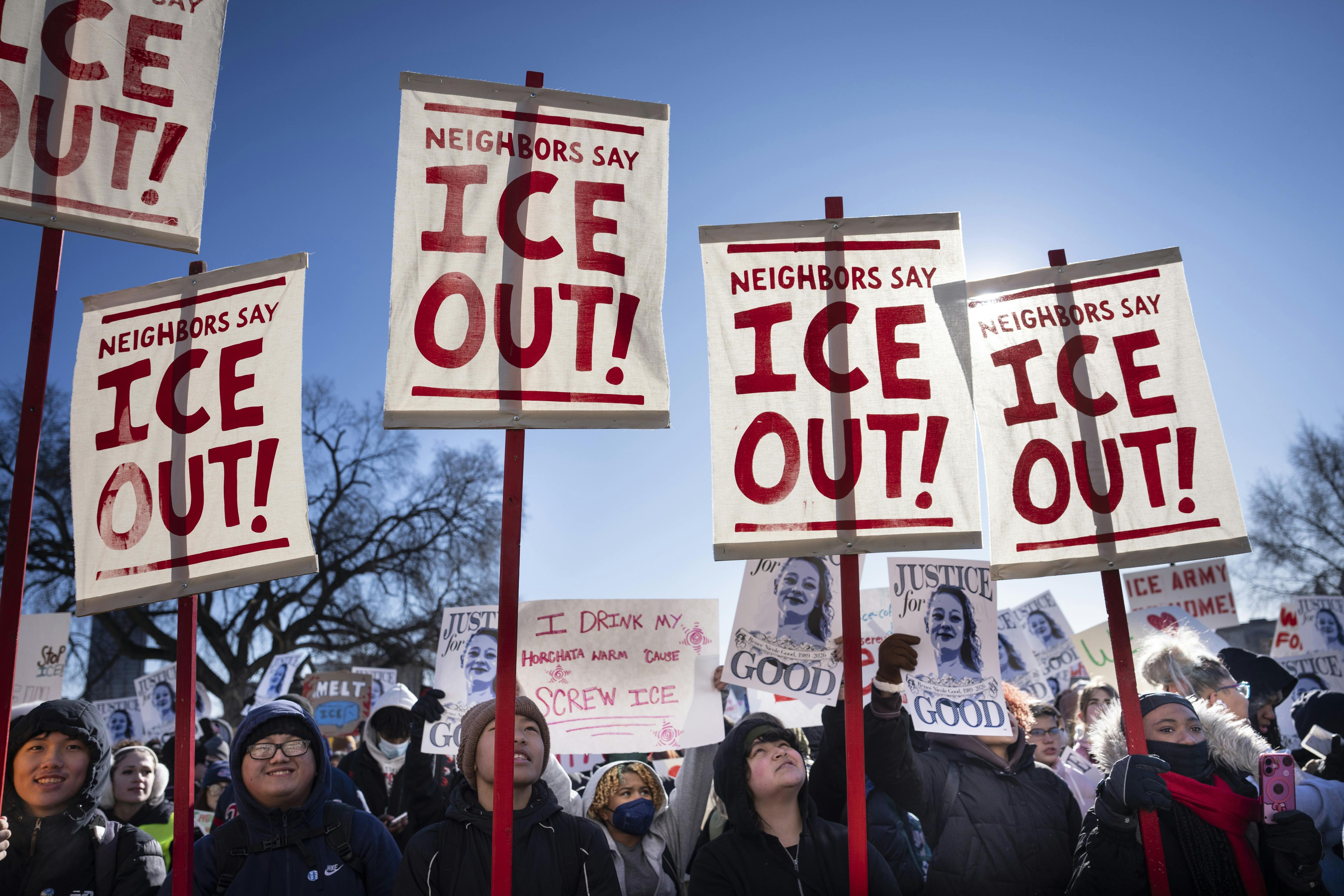 Students hold signs that say, "ICE out!" as they participate in a school walkout in St. Paul, Minnesota