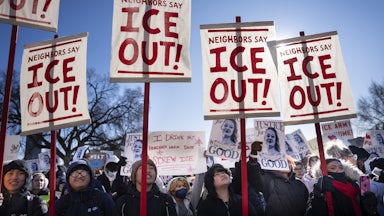 Students hold signs that say, "ICE out!" as they participate in a school walkout in St. Paul, Minnesota
