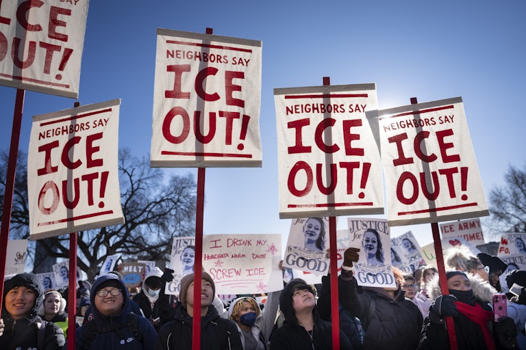 Students hold signs that say, "ICE out!" as they participate in a school walkout in St. Paul, Minnesota