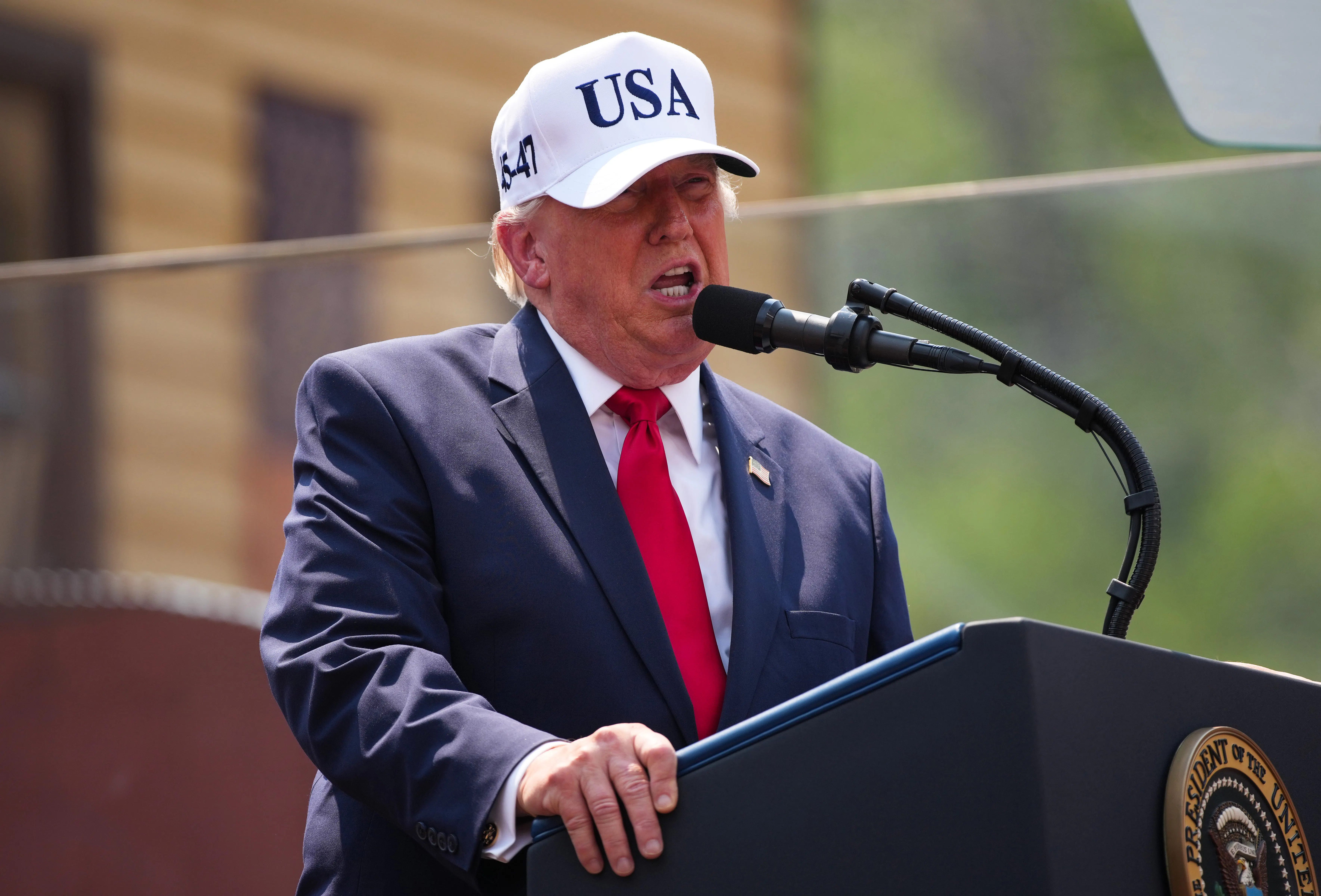 Donald Trump speaks at a podium