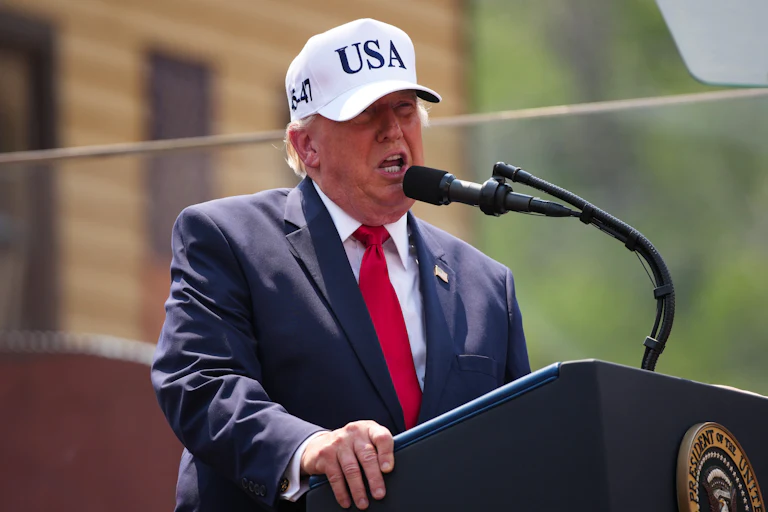 Donald Trump speaks at a podium