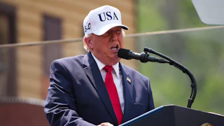 Donald Trump speaks at a podium