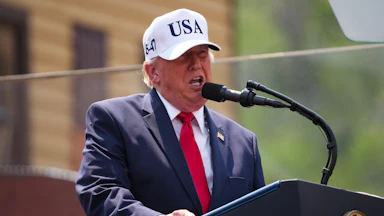 Donald Trump speaks at a podium