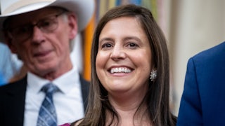 Representative Elise Stefanik smiles while standing in the Oval Office