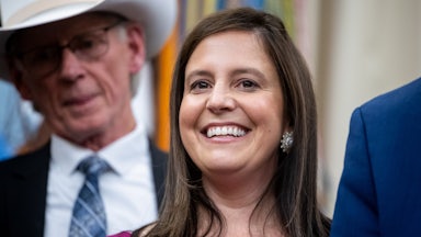 Representative Elise Stefanik smiles while standing in the Oval Office