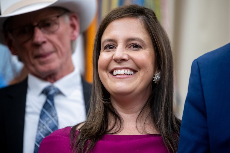 Representative Elise Stefanik smiles while standing in the Oval Office