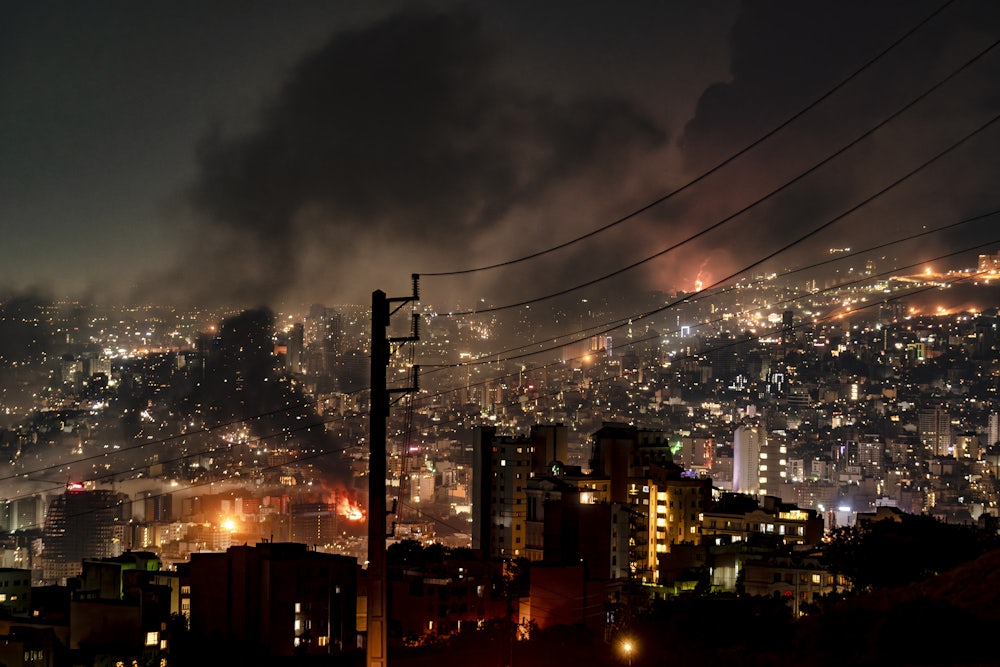 Several fires are burning across a nighttime cityscape. The city is Iran and it's on fire because Israel is bombing it based on questionable intelligence relating to its nuclear program