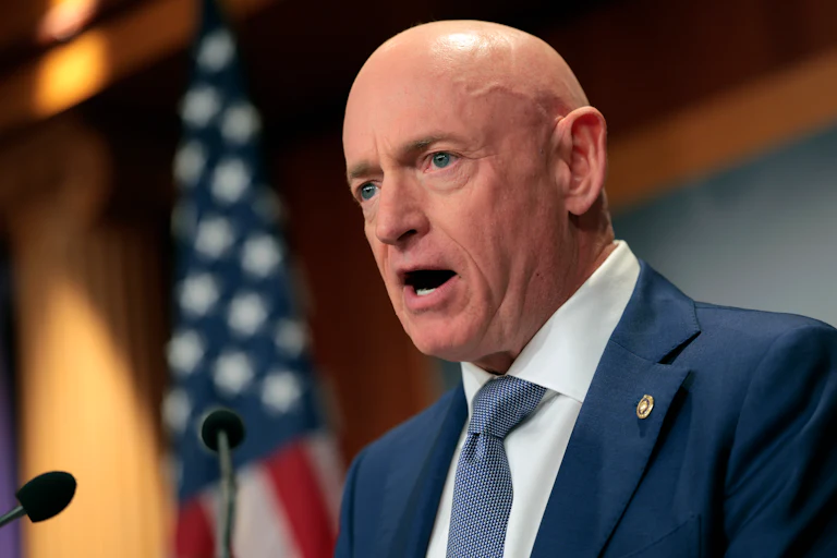 Senator Mark Kelly speaks into a microphone