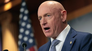 Senator Mark Kelly speaks into a microphone