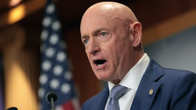 Senator Mark Kelly speaks into a microphone