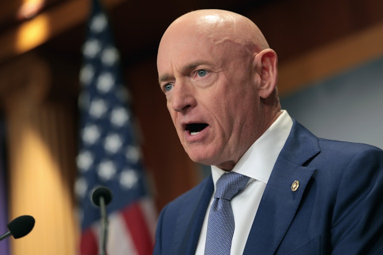 Senator Mark Kelly speaks into a microphone