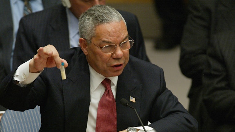 US Secretary of State Colin Powell holds up a vial that he said was the size that could be used to hold anthrax as he addresses the United Nations Security Council .