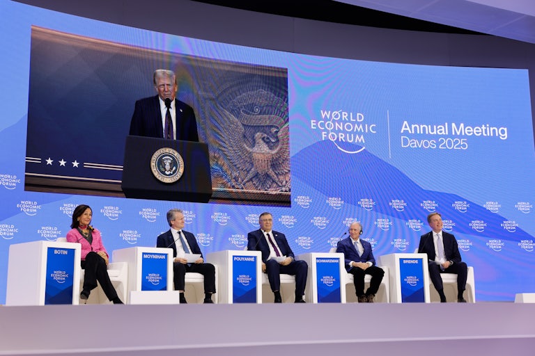 Donald Trump is seen on a screen speaking at a podium during a virtual appearance at the Davos World Economic Forum