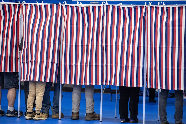 People vote in voting booths