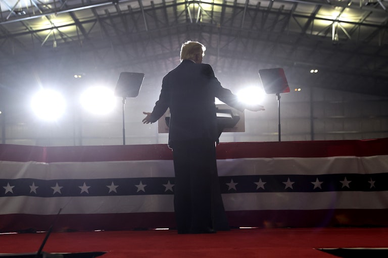 Former President Donald Trump is shown from the back as he speaks at a rally.