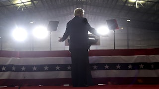 Former President Donald Trump is shown from the back as he speaks at a rally.
