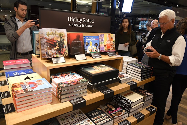 Customers browse the shelves of an Amazon book store.