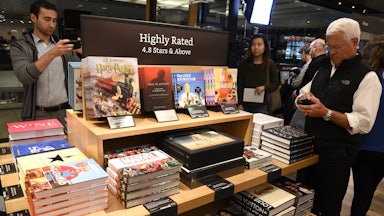 Customers browse the shelves of an Amazon book store.