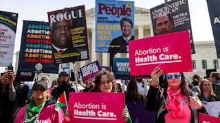 Demonstrators hold pro-choice signs.