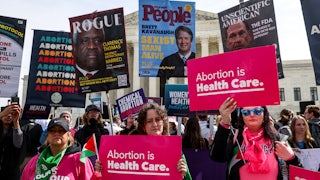 Demonstrators hold pro-choice signs.