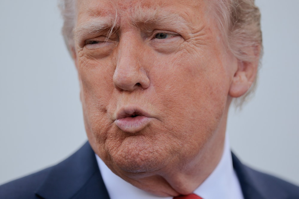 Donald Trump speaks to reporters outside the White House