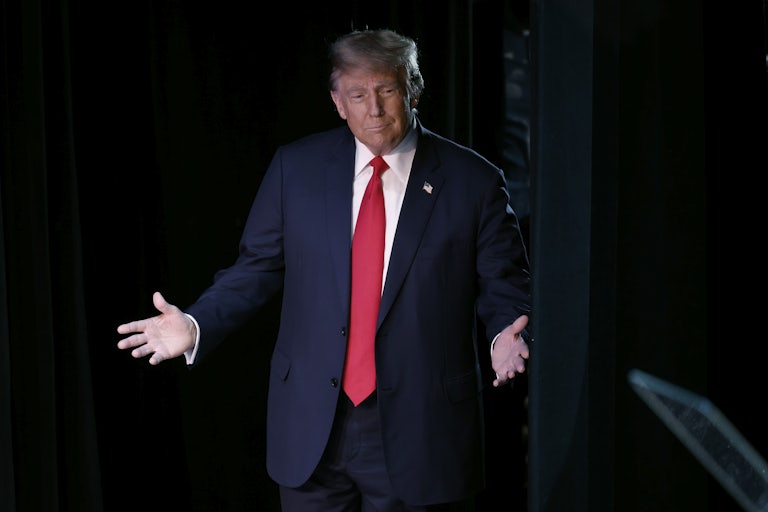 Donald Trump splays both hands outward as if this is a show