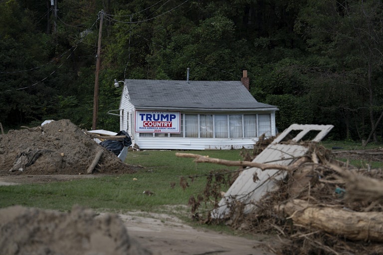 Debris is seen in front of a home with a Trump 2024 campaign sign in Lake Lure, North Carolina, October 2, 2024, after Hurricane Helene.
