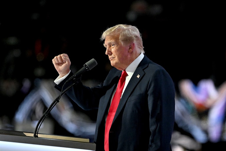 Donald Trump holds up his fist as he speaks onstage at the Republican National Convention