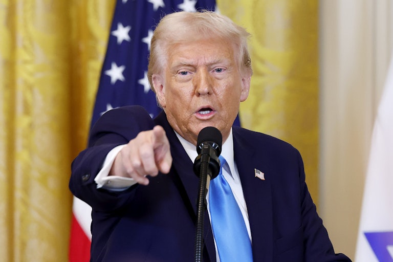 Donald Trump points to someone in the crowd (not pictured) while standing at the presidential podium