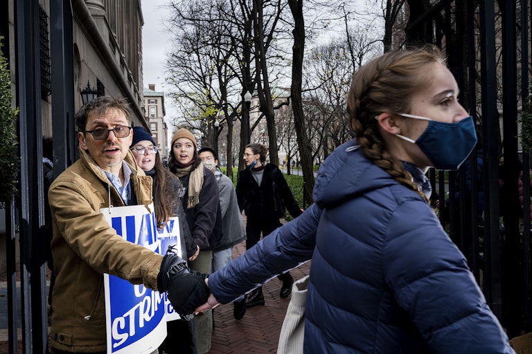striking student workers hold hands on the picket line at Columbia University