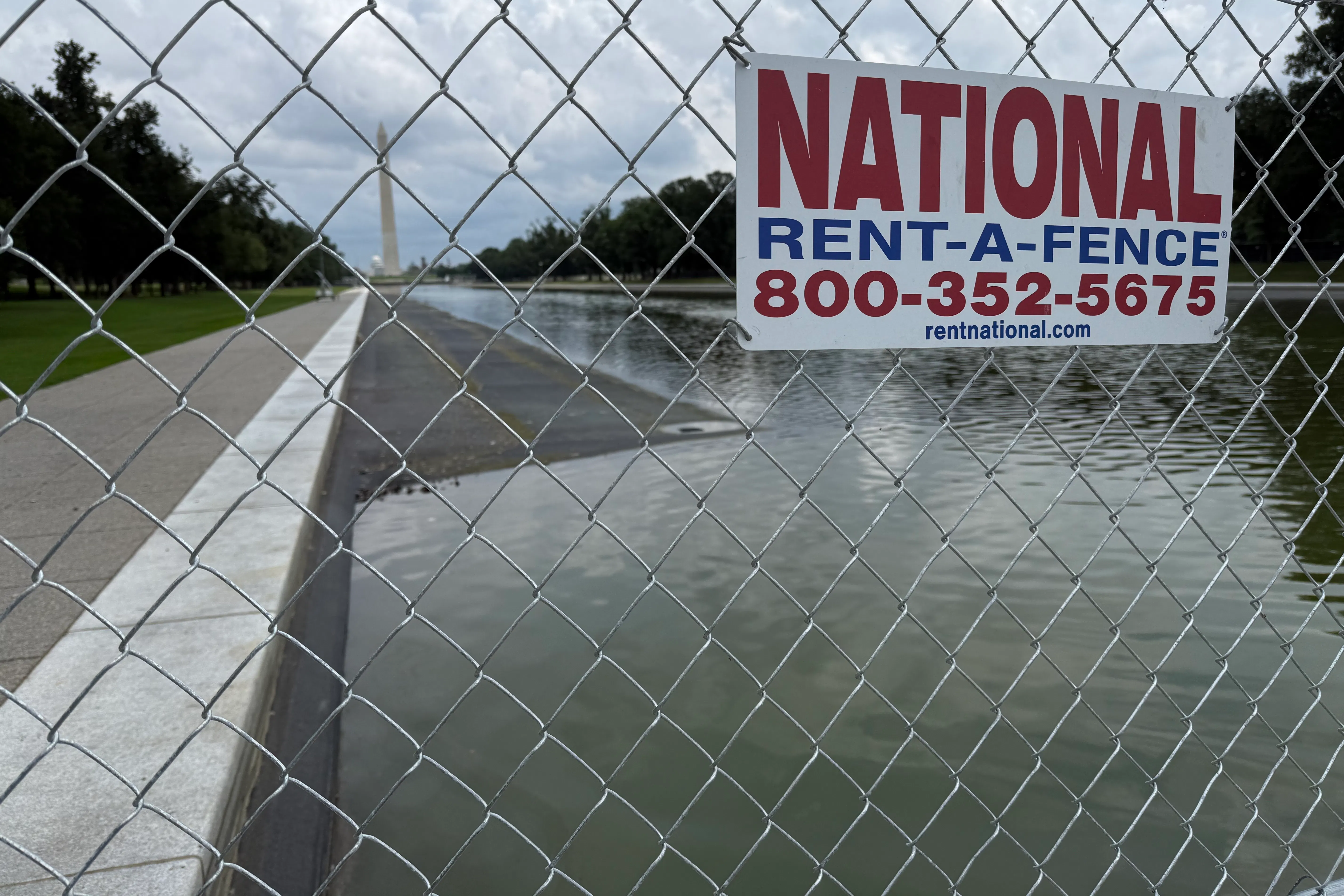 A fence surrounds the drained Reflecting Pool.