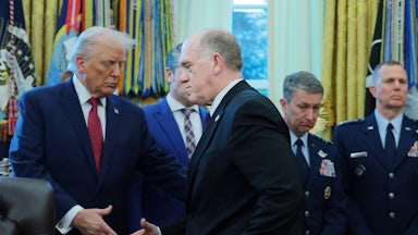 Donald Trump and Tom Homan shake hands in the White House.