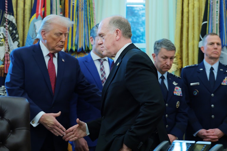 Donald Trump and Tom Homan shake hands in the White House.