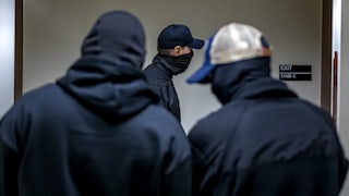 Three masked plainclothes ICE agents