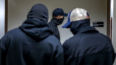 Three masked plainclothes ICE agents