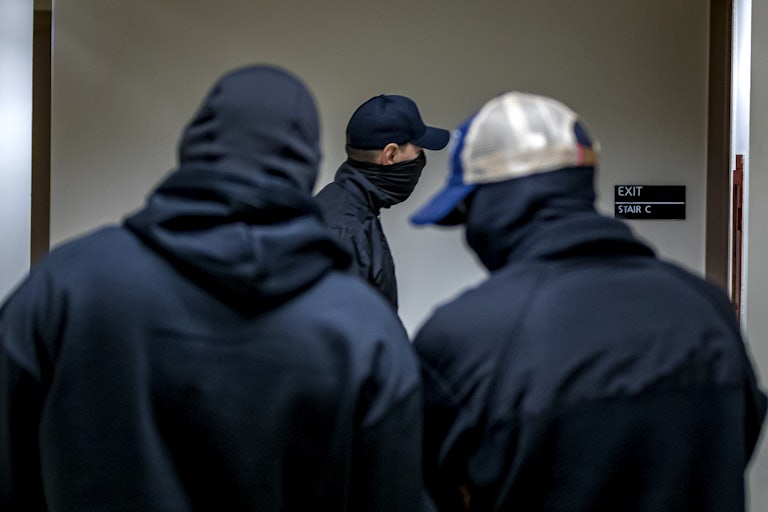 Three masked plainclothes ICE agents