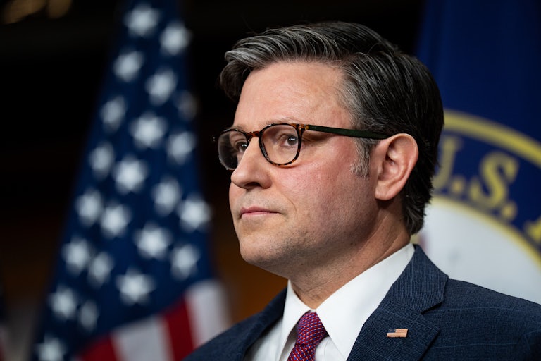 House Speaker Mike Johnson stands during a press conference