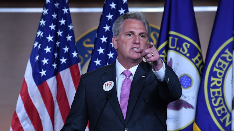 House Minority Leader Kevin McCarthy points from behind a lectern.