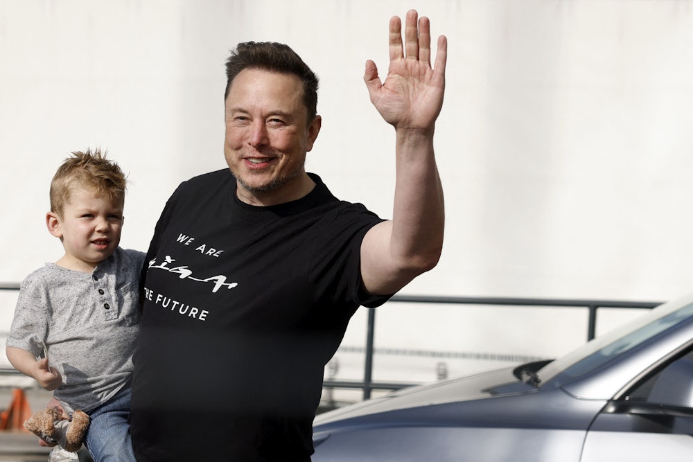 Musk holds his son during a visit to a Tesla plant in Grünheide, Germany