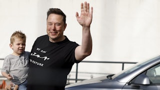 Musk holds his son during a visit to a Tesla plant in Grünheide, Germany