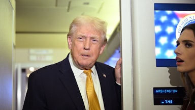 Donald Trump speaks to reporters on Air Force One