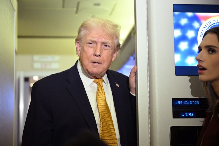 Donald Trump speaks to reporters on Air Force One